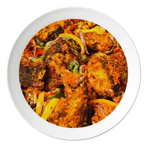 A plate of sautéed croaker fish, with vegetables and Nigerian spices, available in Bolingbrook, Illinois.