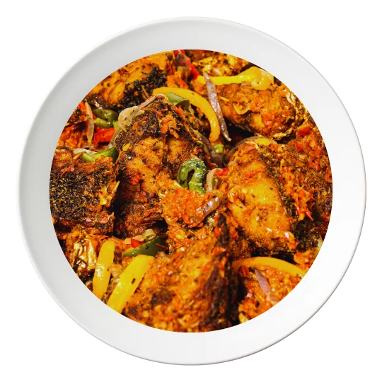 A plate of sautéed croaker fish, with vegetables and Nigerian spices, available in Bolingbrook, Illinois.