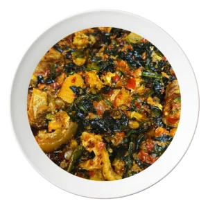 A bowl of Efo Riro, a Nigerian spinach stew with assorted meats, available for delivery in Bolingbrook, Illinois.