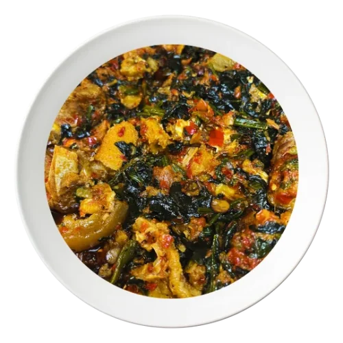 A bowl of Efo Riro, a Nigerian spinach stew with assorted meats, available for delivery in Bolingbrook, Illinois.