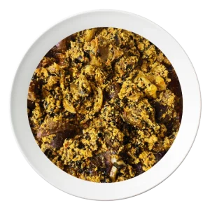 A plate of Egusi soup with spinach, vegetables, and oziza leaf, a flavorful Nigerian dish, order in Bolingbrook, Illinois