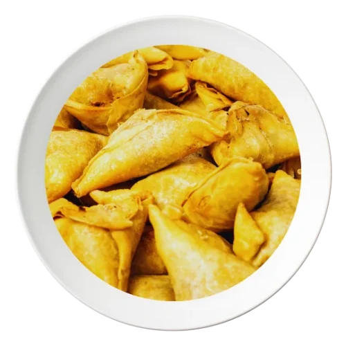 A plate of Samosas, Nigerian-style pastries filled with spiced meat, available in Bolingbrook, Illinois.
