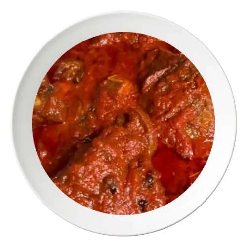 A plate of Stew with fried Tilapia fish, a Nigerian style dish, available in Bolingbrook, Illinois.
